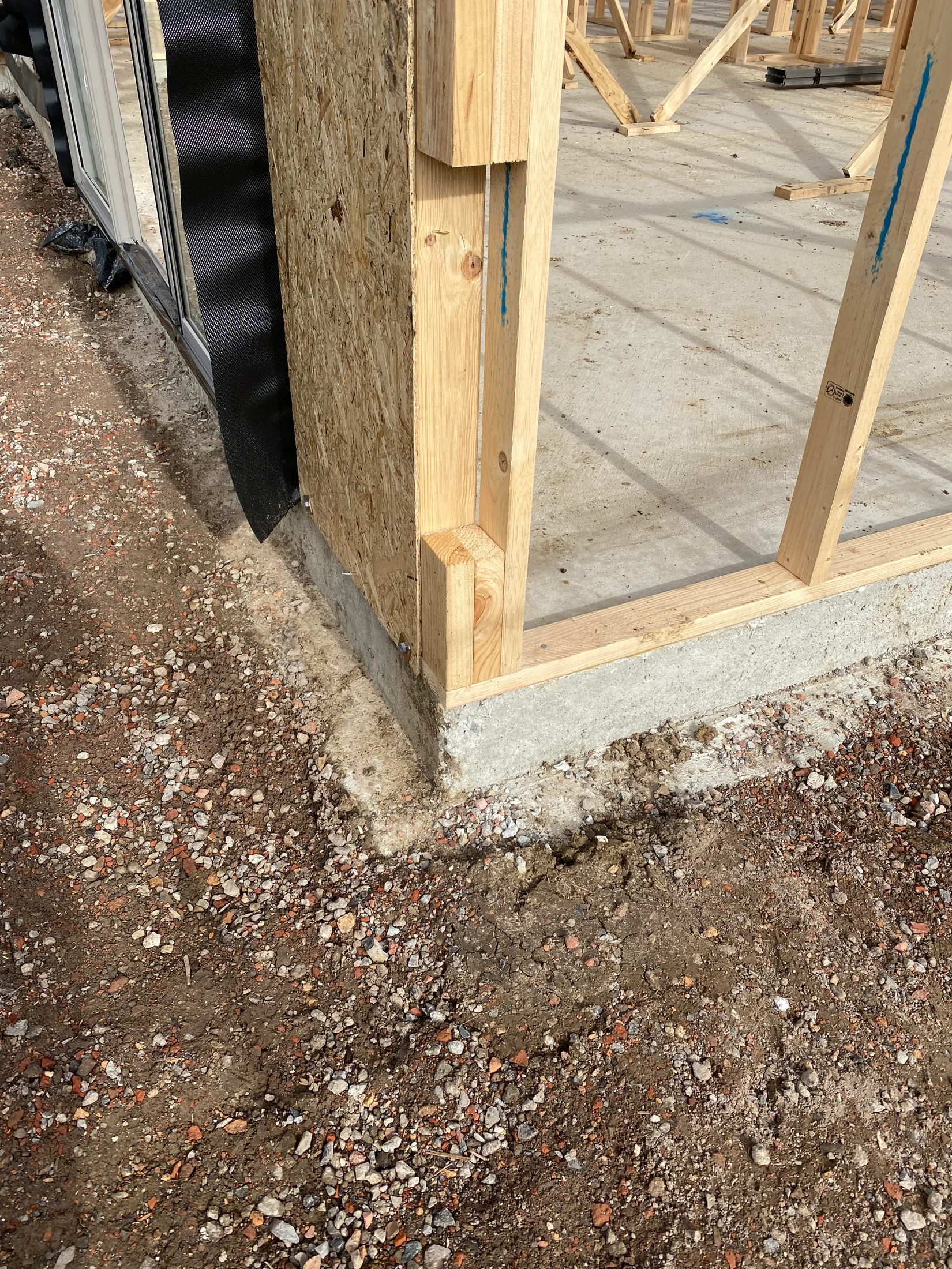 A frame stage build corner connection, with a concrete rebate and backfill shown