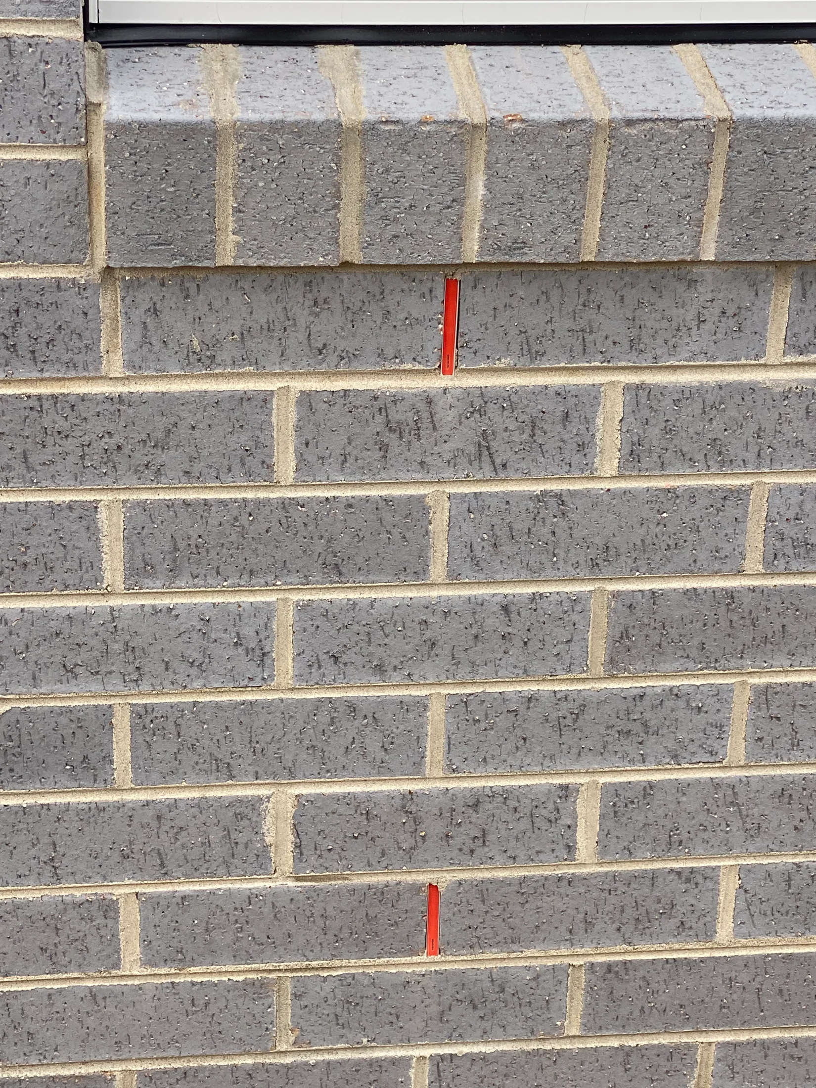A brick sill on new home build with BAL peephole protector installed