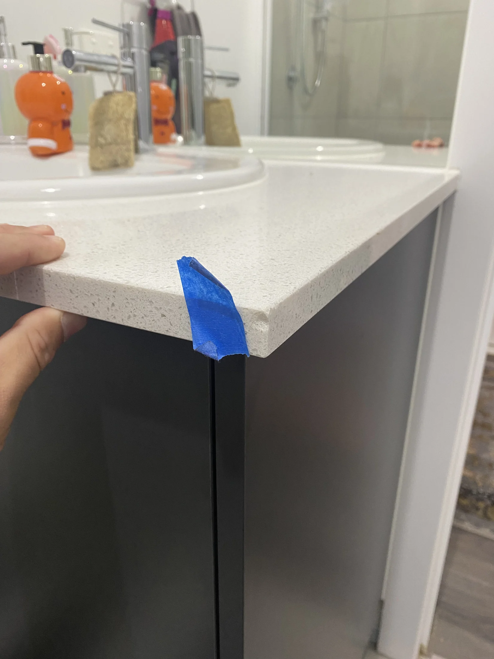 Chipped stone bathroom vanity benchtop identified during new build handover stage inspection