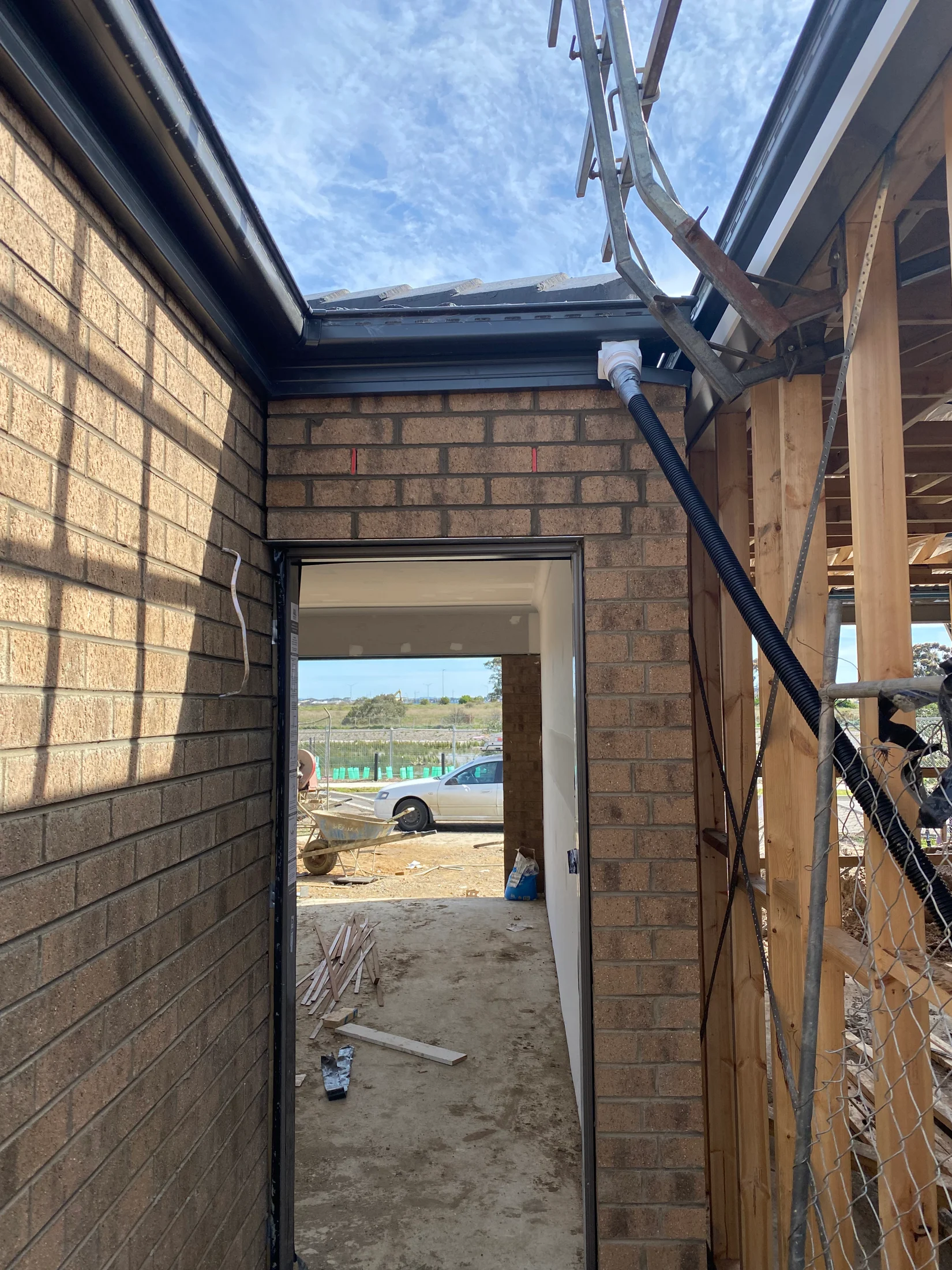 Out of level fascia and gutter at the rear door of a new building being constructed