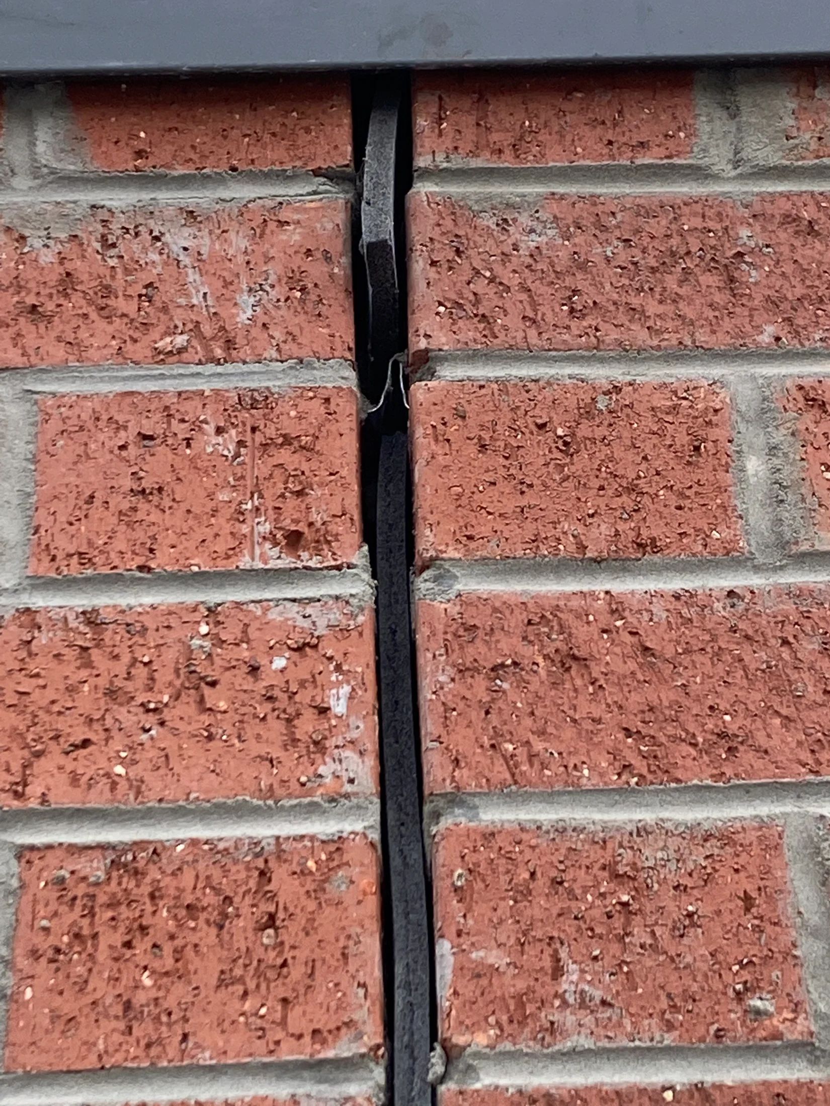 A brick wall articulation joint, uncaulked, showing the abelflex foam.