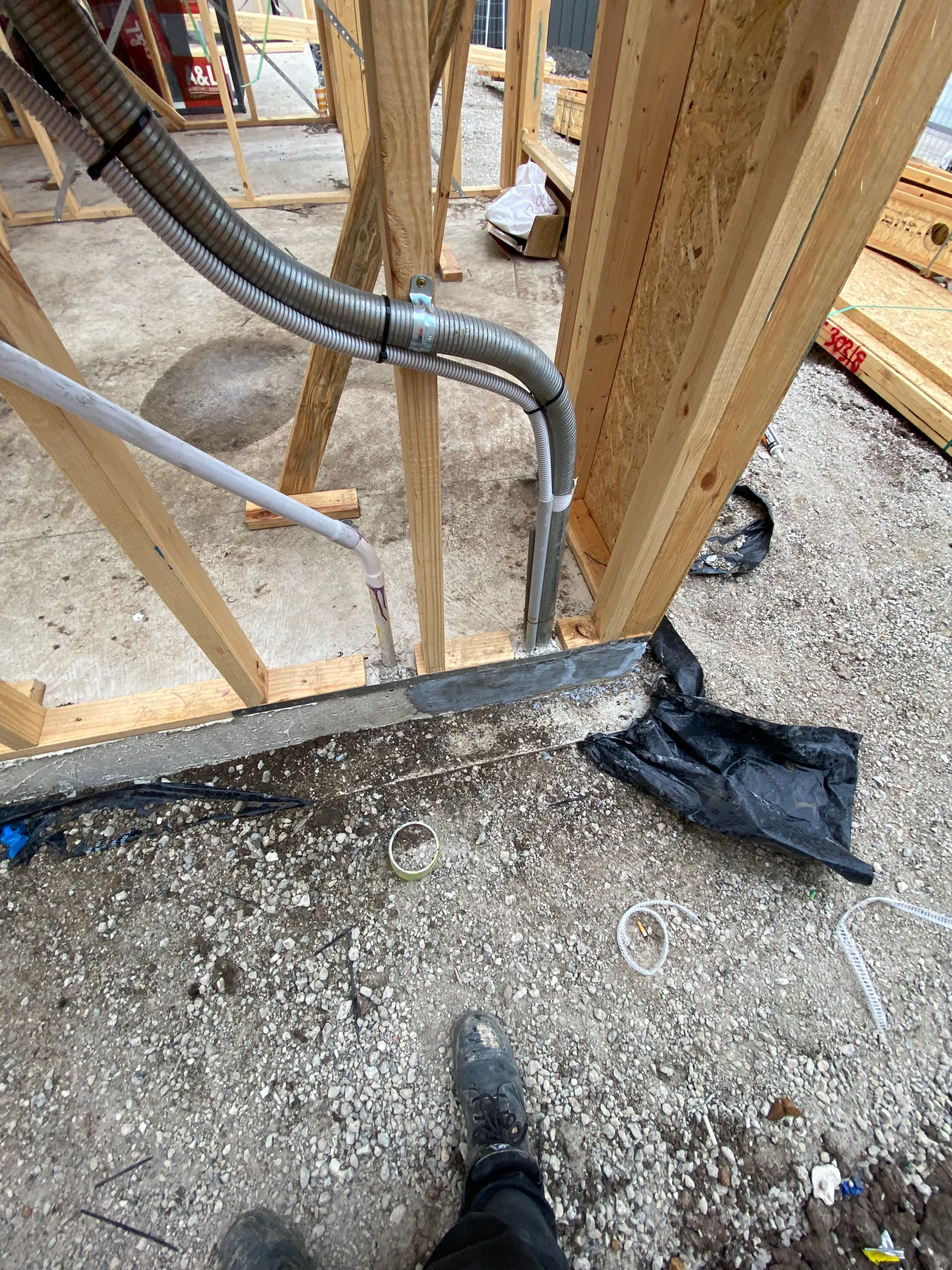 A frame with electrical meter and conduit in view, cut bottom plate with ineffective fixings