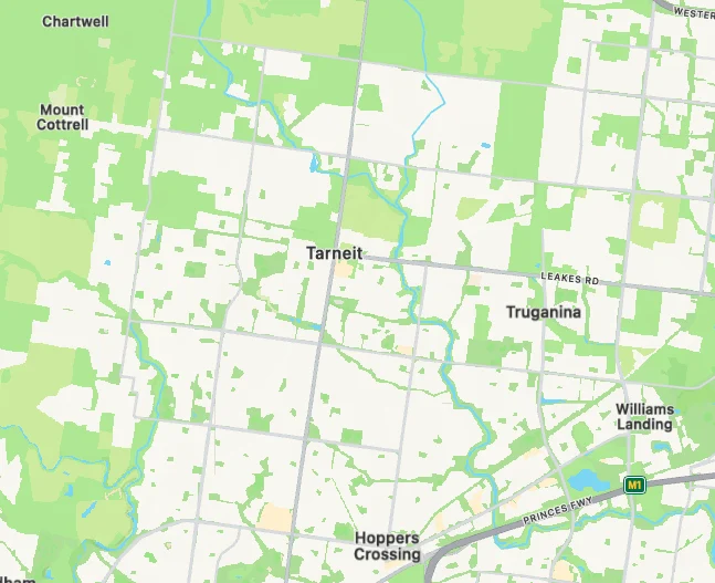 Map displaying areas of Tarneit, Truganina, and Hoppers Crossing. Green and white patterns indicate land use, with labeled roads and locations.